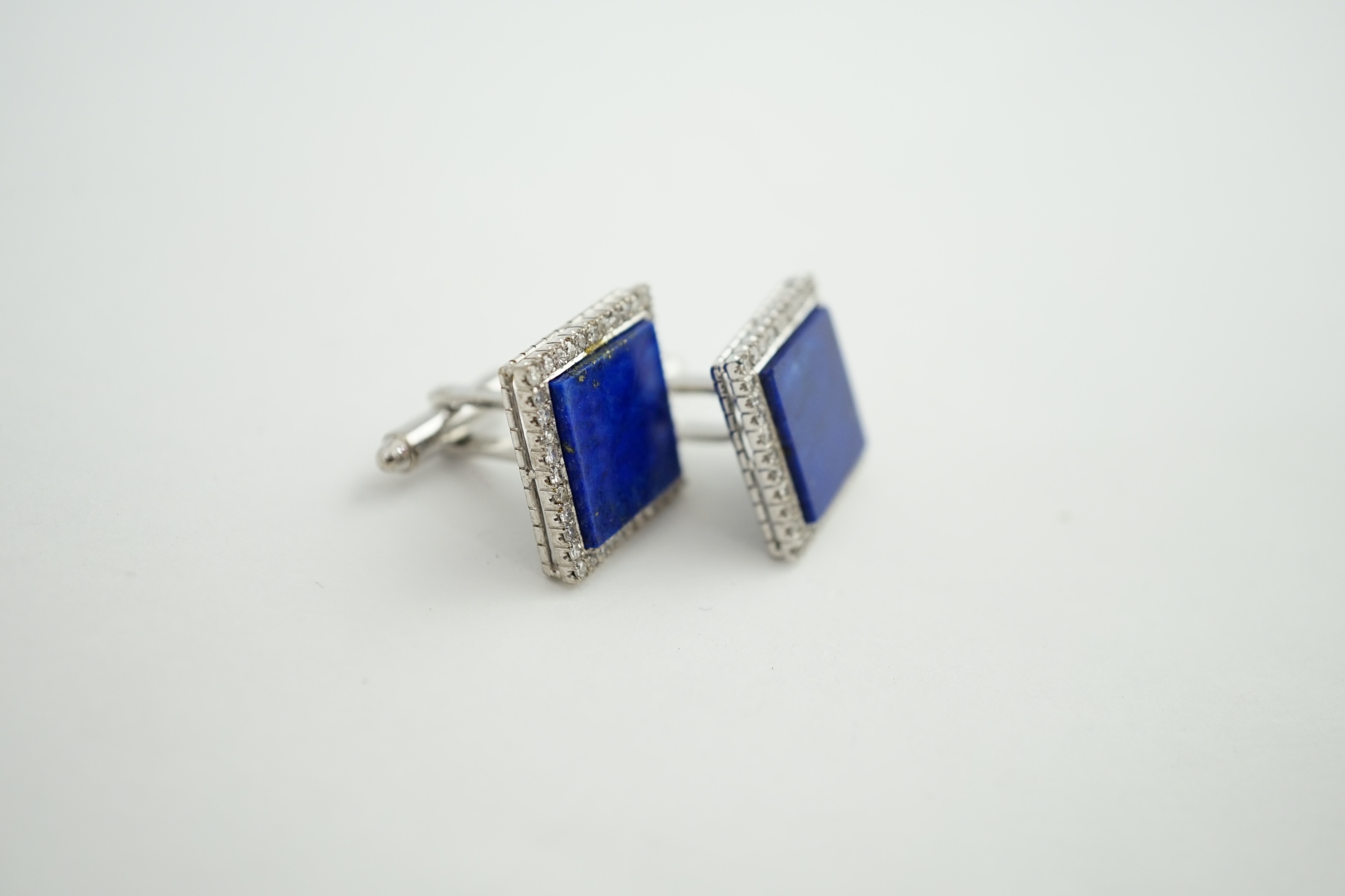 A pair of 18K white gold, lapis lazuli and diamond set tablet cufflinks, each lapis stone surrounded by forty claw set diamonds